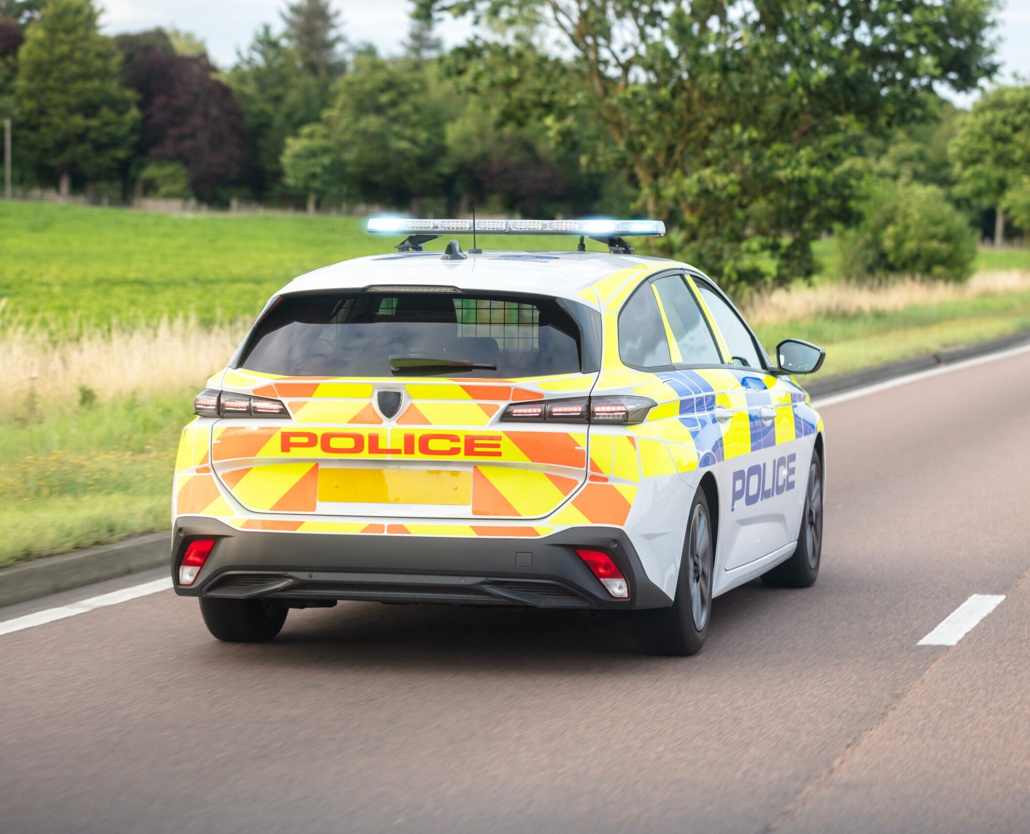 police car driving down the road