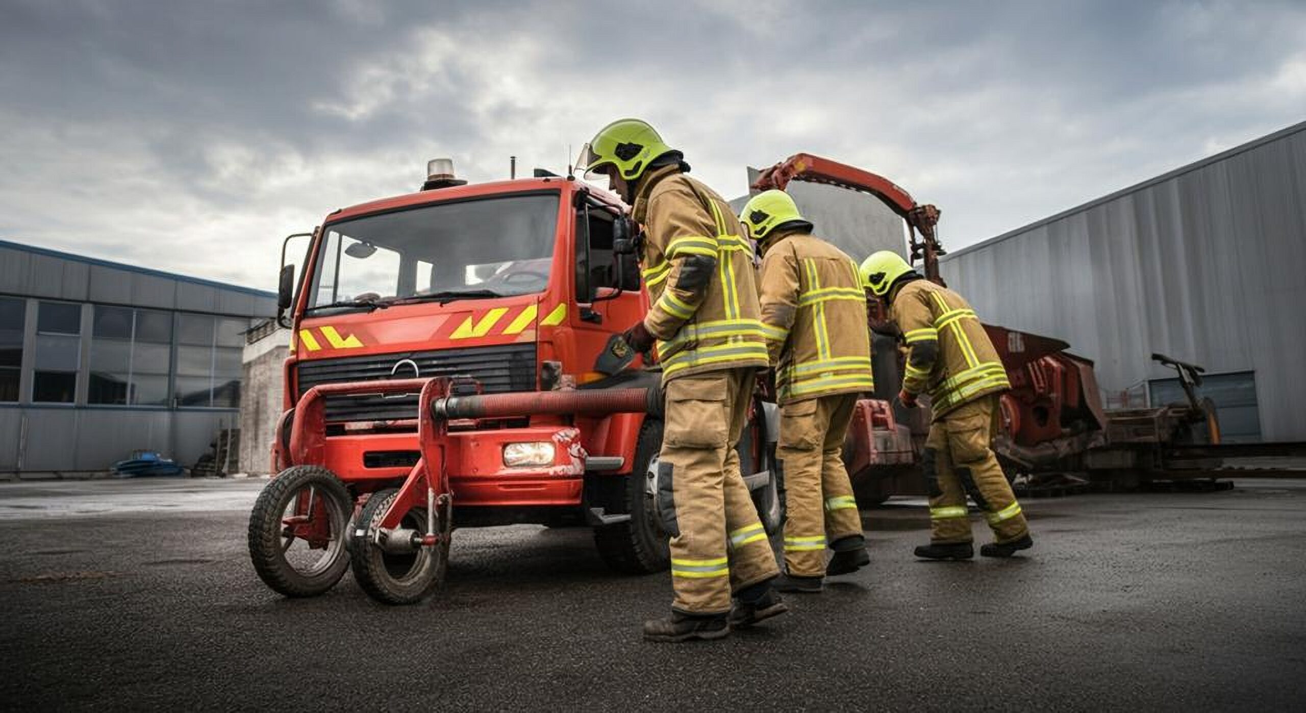 fire service men facing a firetruck
